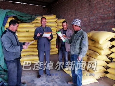 王安义(左二)向村民讲授收购知识(资料图)